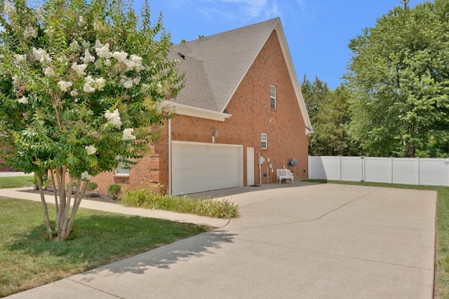 view of home's exterior with a garage and a yard