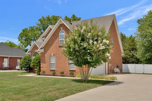 view of front of house with a front lawn and a garage