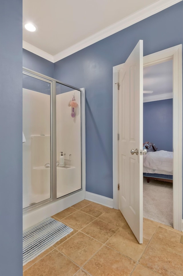 bathroom featuring a shower with door and ornamental molding