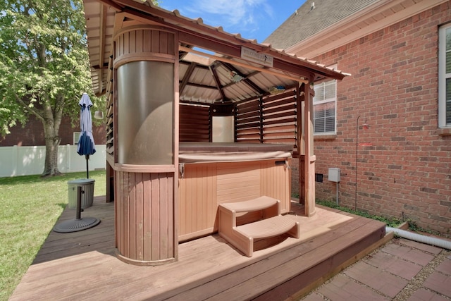 wooden terrace featuring a gazebo and a hot tub