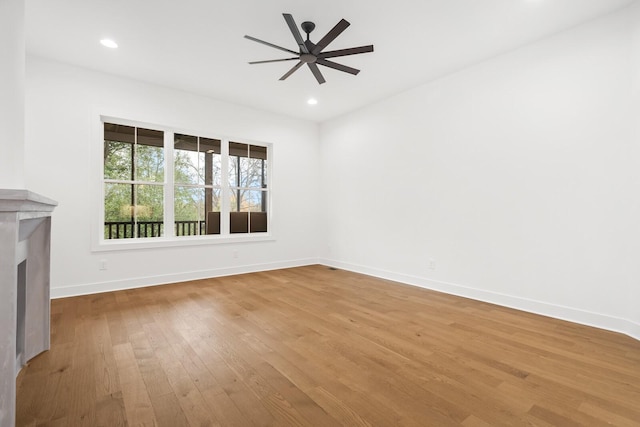 unfurnished living room featuring hardwood / wood-style flooring and ceiling fan