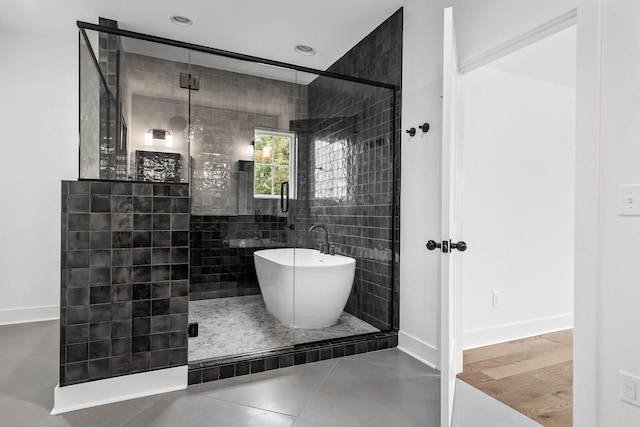 bathroom featuring tile patterned floors and separate shower and tub