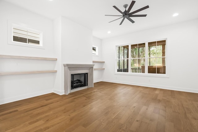 unfurnished living room with ceiling fan and hardwood / wood-style flooring