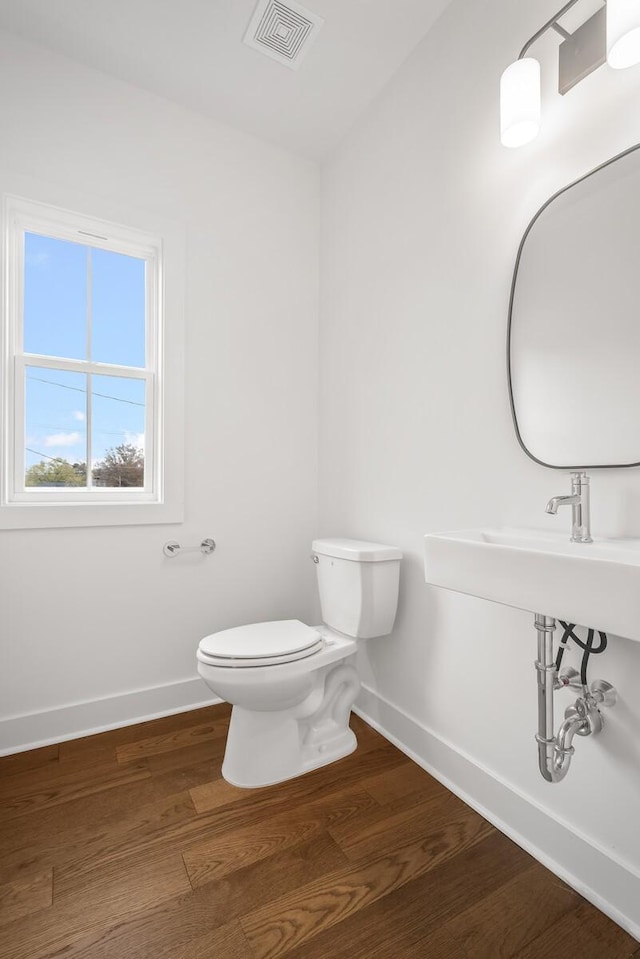 bathroom featuring toilet and hardwood / wood-style floors