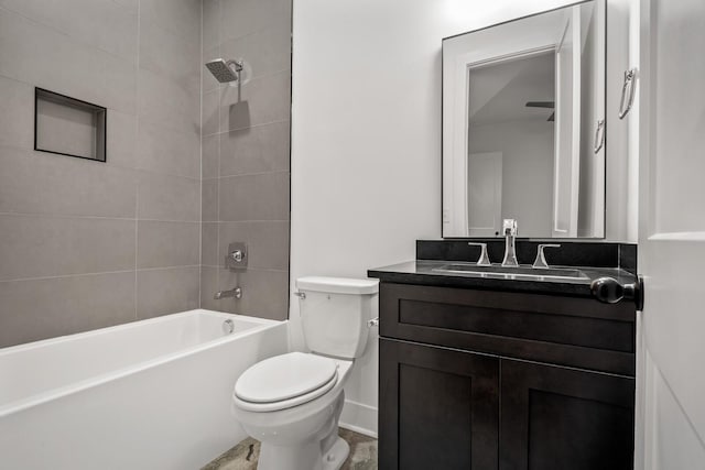 full bathroom featuring toilet, tiled shower / bath combo, and vanity