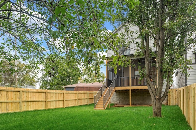 back of property featuring a sunroom and a yard