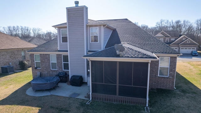 back of property featuring central AC, a lawn, a sunroom, and a patio