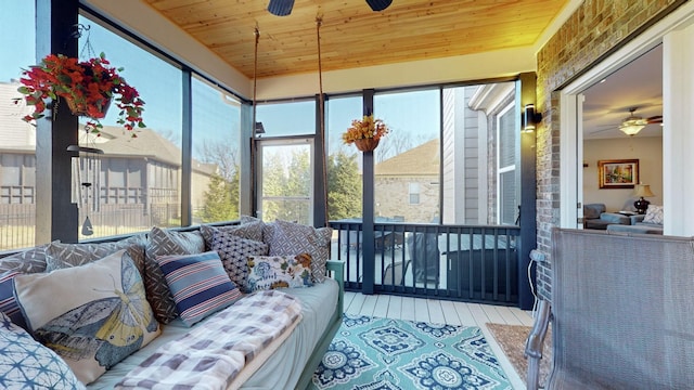 sunroom with ceiling fan and wooden ceiling