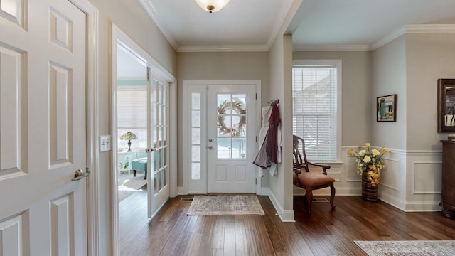 foyer entrance with ornamental molding and dark hardwood / wood-style flooring