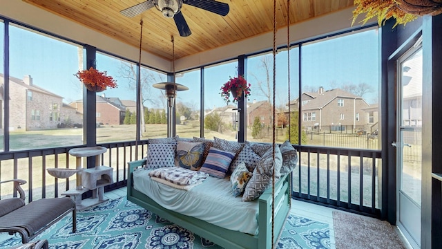 sunroom featuring a wealth of natural light, wooden ceiling, and ceiling fan