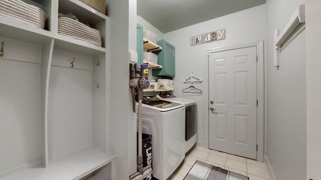 clothes washing area with light tile patterned flooring and independent washer and dryer