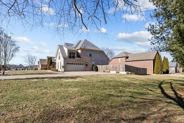 view of side of home with a yard and a garage