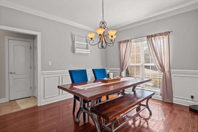 dining space with ornamental molding, dark hardwood / wood-style floors, and a chandelier