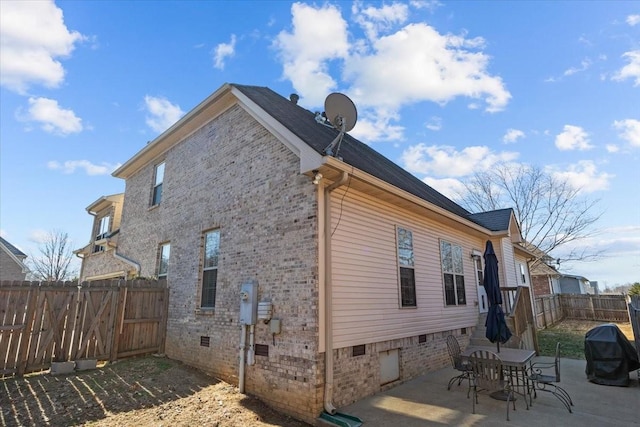 view of side of home with a patio