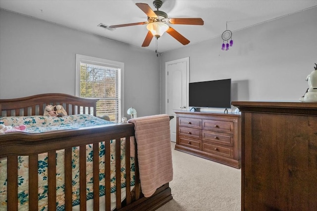 bedroom with ceiling fan and light carpet