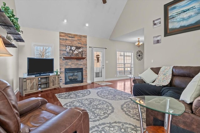 living room with wood-type flooring, a fireplace, and high vaulted ceiling