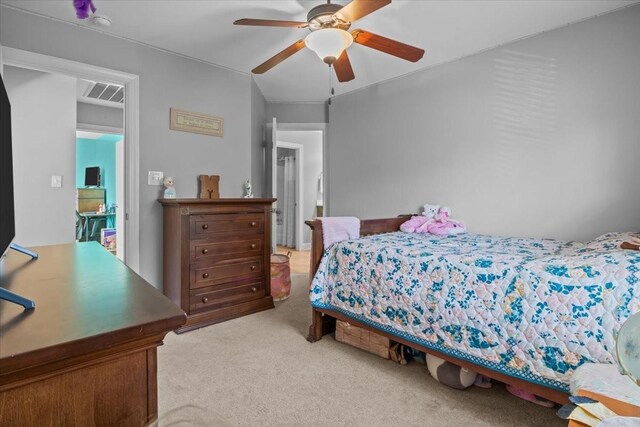 bedroom with ceiling fan and light colored carpet