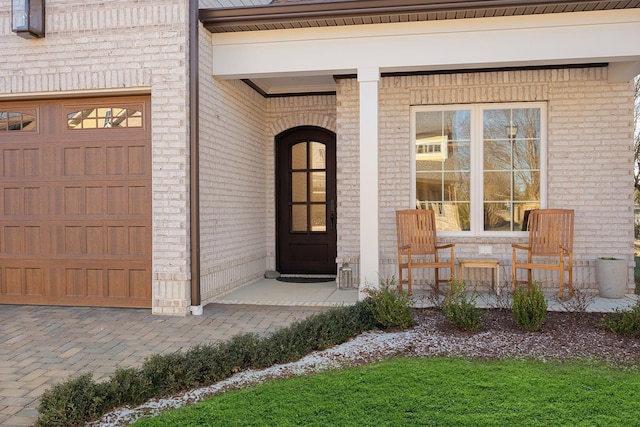 entrance to property with a garage and covered porch