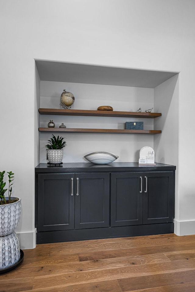 bar with hardwood / wood-style flooring