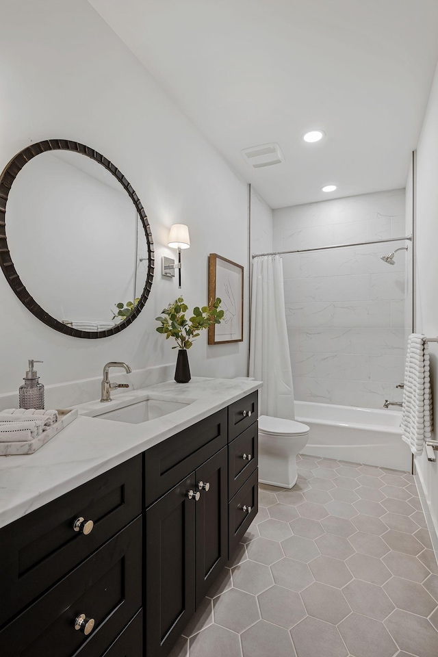 full bathroom with shower / bathtub combination with curtain, vanity, toilet, and tile patterned floors