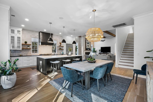 dining space featuring hardwood / wood-style flooring and an inviting chandelier