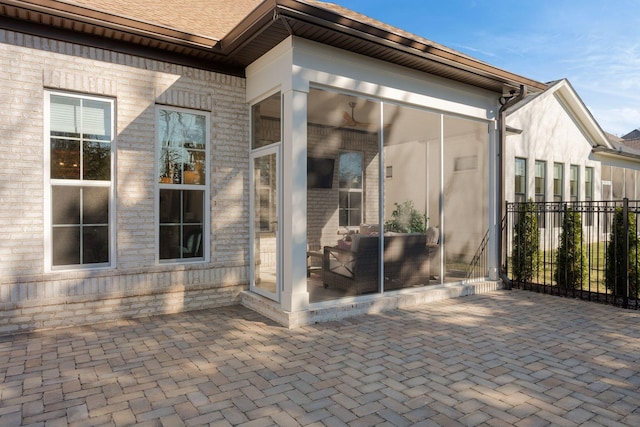 view of exterior entry with a patio area