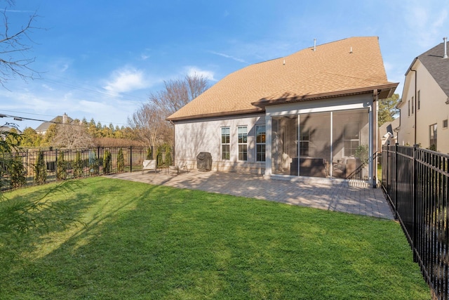 back of property featuring a patio area, a sunroom, and a lawn