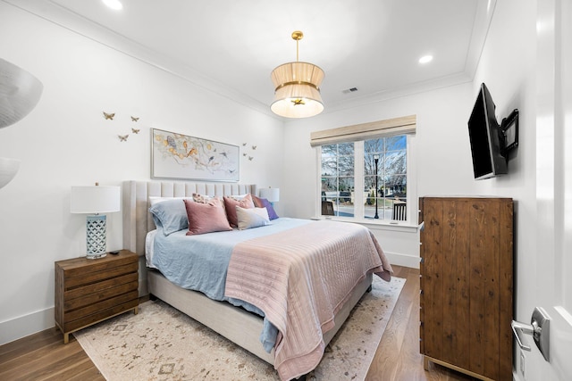 bedroom with ornamental molding and light wood-type flooring