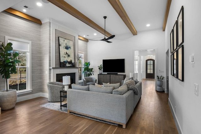 living room with beamed ceiling, dark hardwood / wood-style floors, and ceiling fan