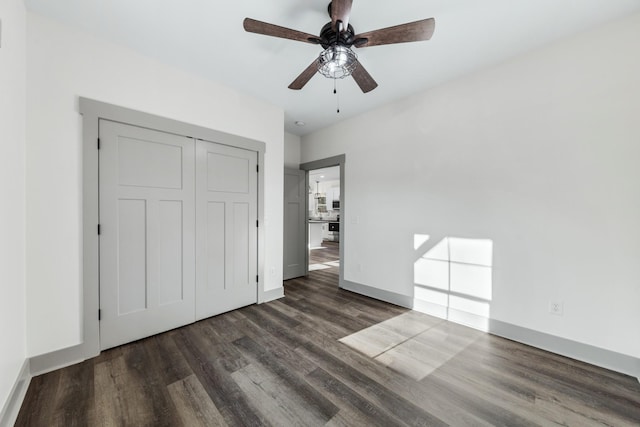 unfurnished bedroom with ceiling fan, a closet, and dark hardwood / wood-style floors