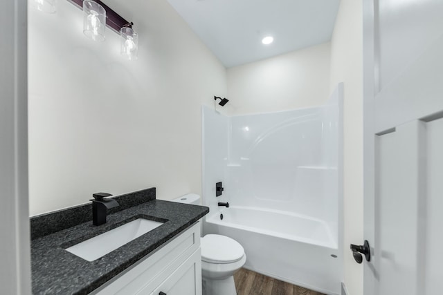 full bathroom featuring toilet, hardwood / wood-style floors, vanity, and shower / bathing tub combination