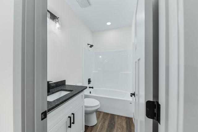 full bathroom with toilet, vanity, wood-type flooring, and bathing tub / shower combination