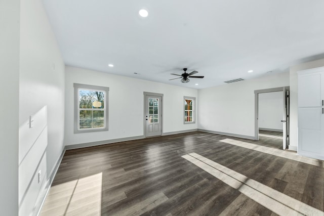 unfurnished living room featuring ceiling fan and dark hardwood / wood-style flooring