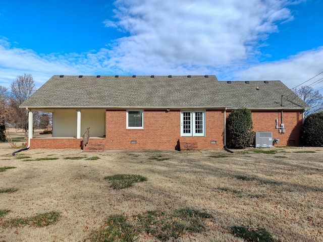 back of house with central AC, a patio area, and a yard