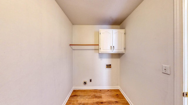 laundry area featuring cabinets, hookup for a washing machine, and light wood-type flooring