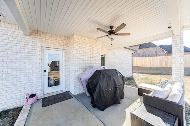 view of patio featuring ceiling fan, a grill, and an outdoor living space