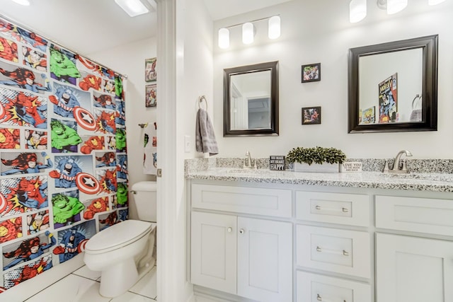 bathroom with toilet, tile patterned floors, and vanity