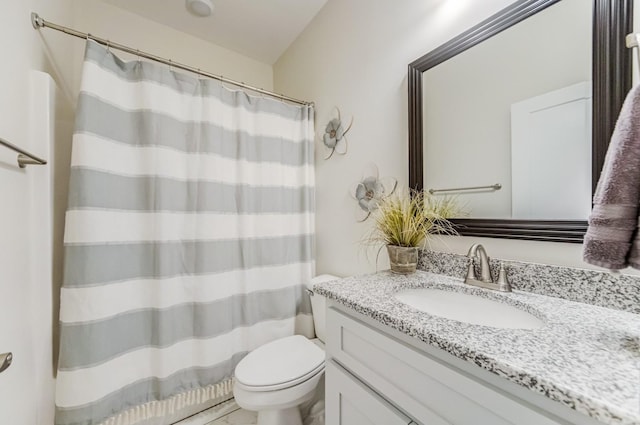 bathroom with toilet and vanity