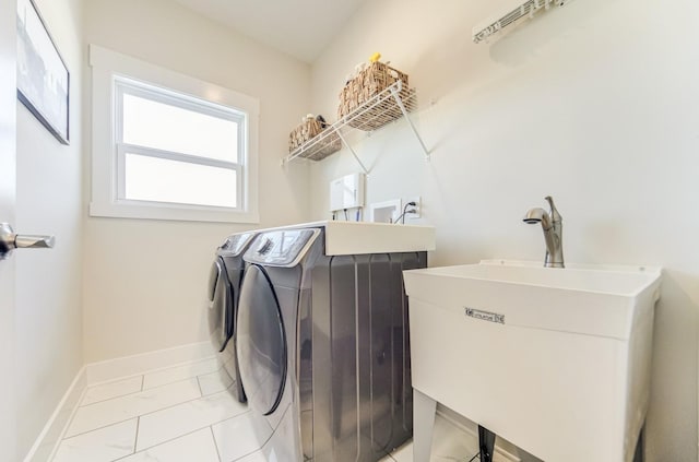 clothes washing area with sink and separate washer and dryer