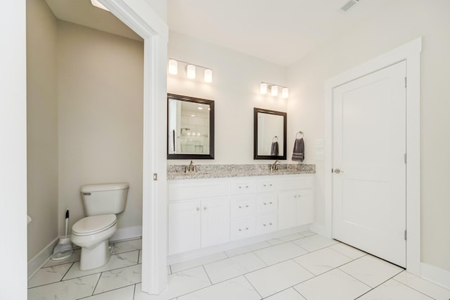 bathroom with toilet and vanity