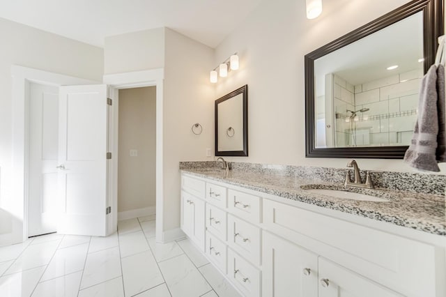 bathroom featuring a shower with door and vanity