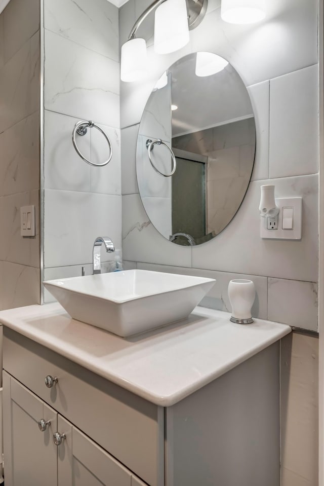 bathroom with vanity and tile walls