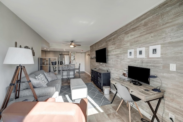 living room with ceiling fan and wooden walls