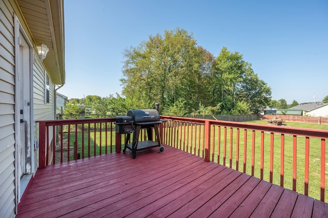 deck with a grill and a lawn