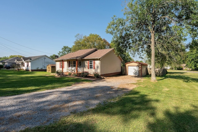 single story home with a front lawn, a garage, an outbuilding, and a porch