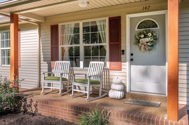 view of exterior entry with a porch