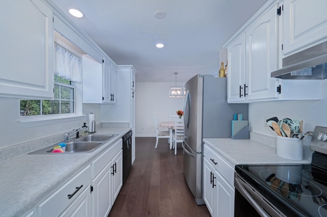 kitchen featuring decorative light fixtures, white cabinets, and electric range