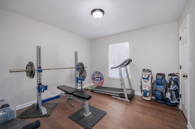 workout area with dark hardwood / wood-style floors