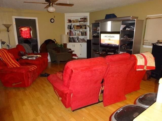 living room with ceiling fan and light wood-type flooring