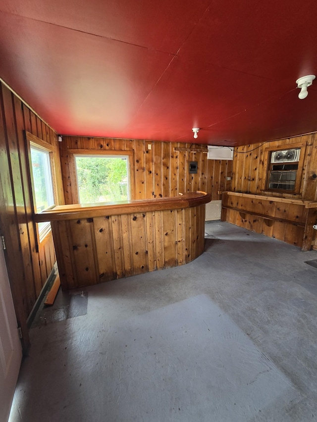 interior space featuring wood walls and bar area